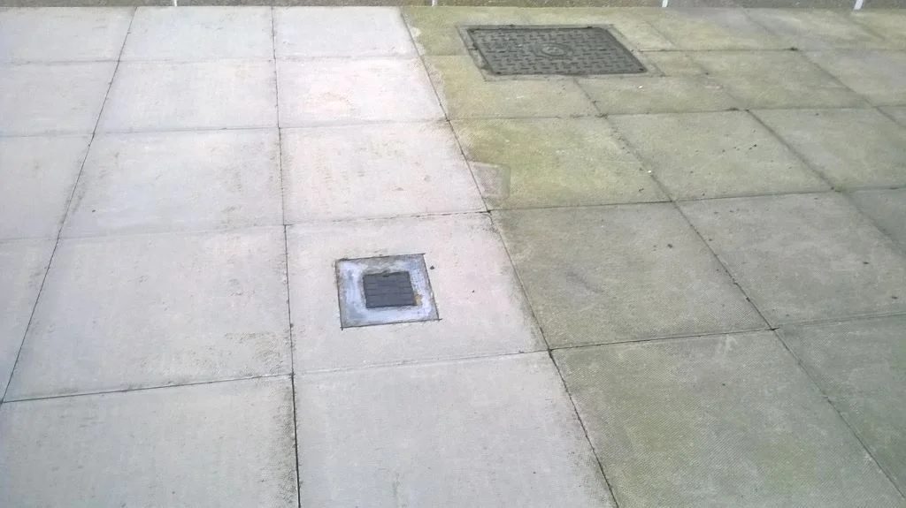 Paving with an inspection cover set into it
